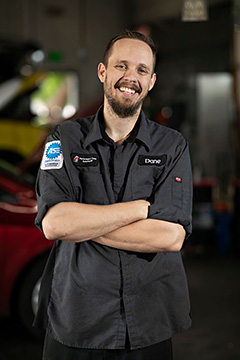 Smiling mechanic in auto repair shop