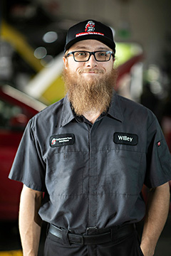 Auto mechanic in uniform inside workshop